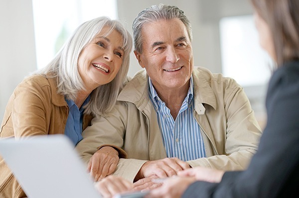 Senior couple speaking with advisor