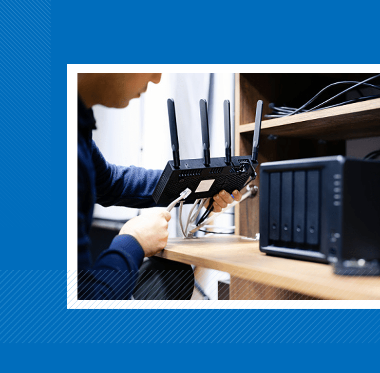 Man plugging ethernet cord into router